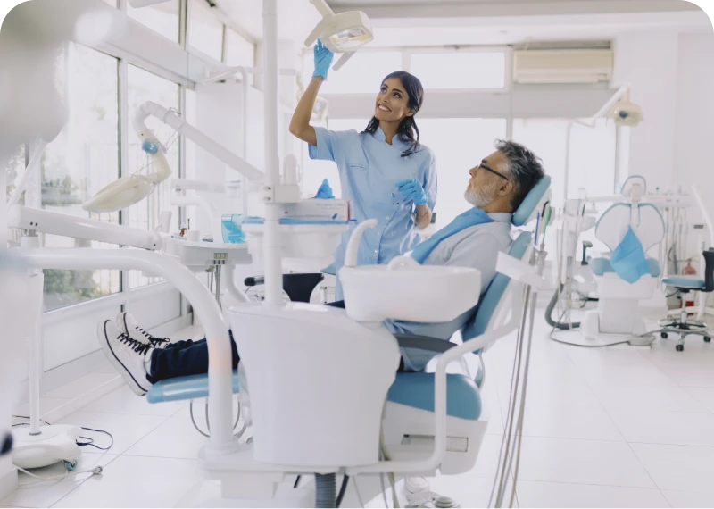 Dentist adjusting light for patient