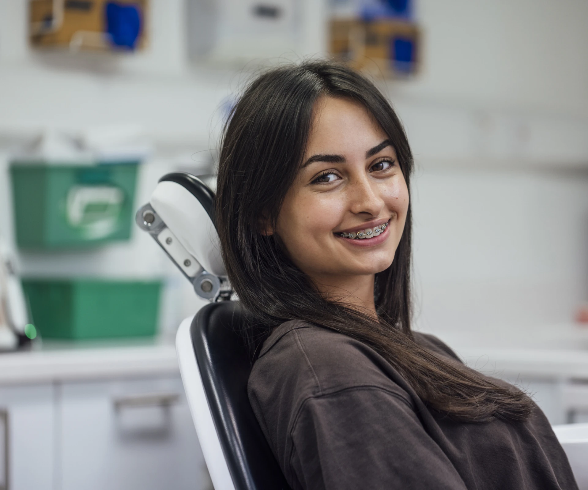 Girl with braces in dental chair