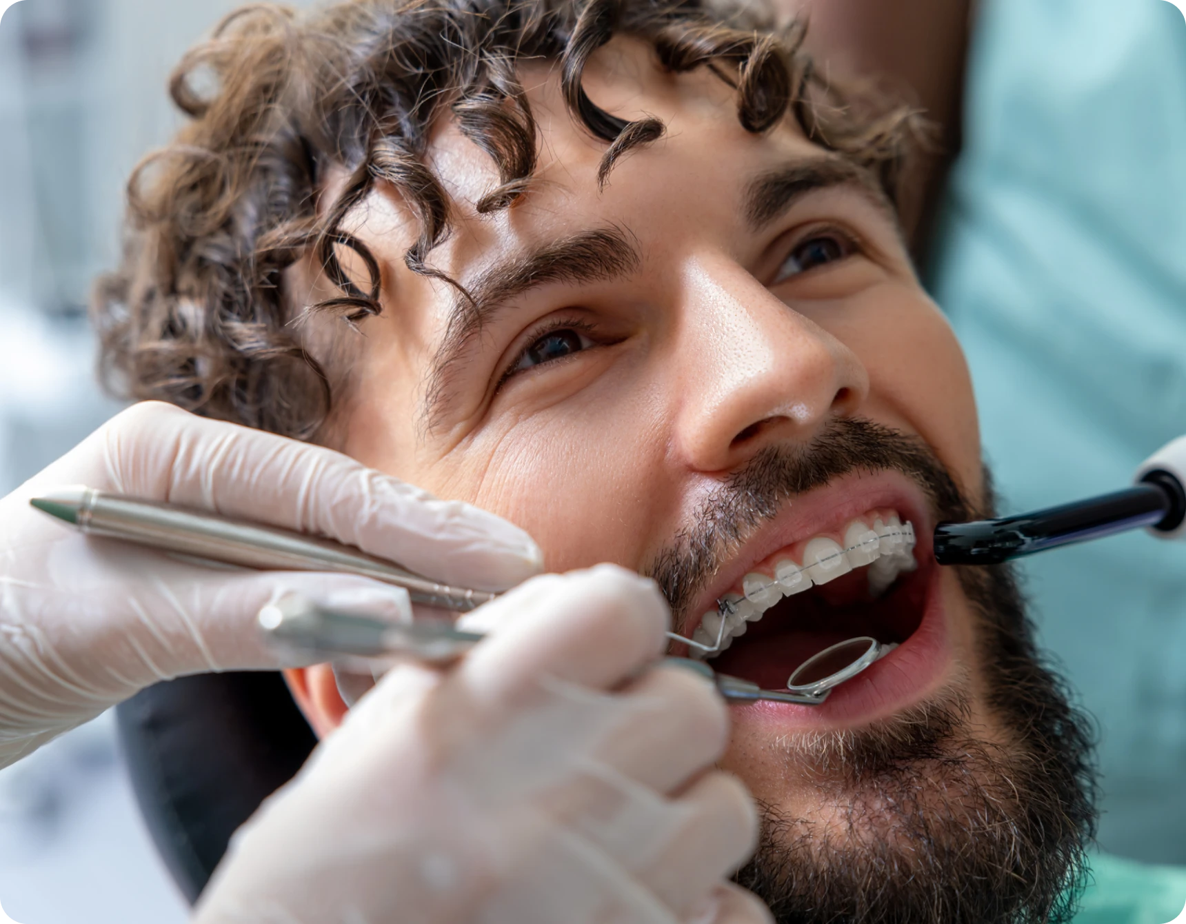 Man receiving dental checkup with braces